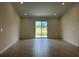 Spacious living room featuring tile flooring and sliding glass doors at 280 Harper Estates Cir, Lake Wales, FL 33859