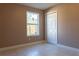 Neutral bedroom featuring a large window, and a closet with white doors at 3426 Somerset Ave, Deltona, FL 32738