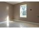 Light-filled bedroom with tile floors, a large window, and neutral decor at 3426 Somerset Ave, Deltona, FL 32738