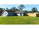Charming single-story home featuring a spacious front yard with lush grass and a newly installed wooden fence at 3426 Somerset Ave, Deltona, FL 32738
