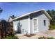 Side view of a home with light blue siding, showcasing a well-maintained exterior and mature landscaping at 3426 Somerset Ave, Deltona, FL 32738