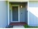 Close-up of a front door with a detailed window, framed by light blue siding and white trim at 3426 Somerset Ave, Deltona, FL 32738