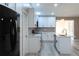Open concept kitchen with stainless steel appliances and white cabinets at 3426 Somerset Ave, Deltona, FL 32738