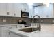 Bright kitchen with white cabinets, stainless steel appliances, and a large sink at 3426 Somerset Ave, Deltona, FL 32738