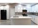 Modern kitchen featuring white cabinets, stainless steel appliances, and stylish pendant lighting over an island at 3426 Somerset Ave, Deltona, FL 32738