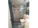 Bathroom featuring a glass shower, white vanity, and blue walls at 3475 Flossmoor Ave # 103, Orlando, FL 32822