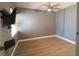 Bedroom with wood-look floors, neutral paint, a ceiling fan, and a window at 3475 Flossmoor Ave # 103, Orlando, FL 32822