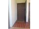 Close-up of the front door featuring a patterned design, tiled entryway, and welcome mat at 3475 Flossmoor Ave # 103, Orlando, FL 32822