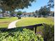 Well-maintained community grounds with lush green spaces, walkways, and mature trees at 3475 Flossmoor Ave # 103, Orlando, FL 32822