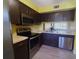 This kitchen features wood cabinets, stainless steel appliances, and light countertops at 3475 Flossmoor Ave # 103, Orlando, FL 32822