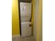 White stackable washer and dryer unit inside the laundry room at 3475 Flossmoor Ave # 103, Orlando, FL 32822