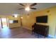 Open-concept living room with a piano, wood-look floors, and yellow walls at 3475 Flossmoor Ave # 103, Orlando, FL 32822