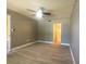 Spacious living room with wood-look floors and neutral paint at 3475 Flossmoor Ave # 103, Orlando, FL 32822