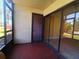 Enclosed patio with tile flooring, sliding glass doors, and views of the community grounds at 3475 Flossmoor Ave # 103, Orlando, FL 32822