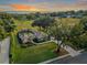Aerial view of a home on a spacious lot with mature trees, lush landscaping and golf course view at 39342 Harbor Hills Blvd, Lady Lake, FL 32159