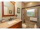 Well-lit bathroom featuring granite countertops, tiled shower and matching framed mirror at 39342 Harbor Hills Blvd, Lady Lake, FL 32159