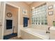 This stunning bathroom features a soaking tub and a glass block window at 39342 Harbor Hills Blvd, Lady Lake, FL 32159