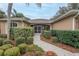 Inviting front entrance with a screened-in porch and manicured landscaping at 39342 Harbor Hills Blvd, Lady Lake, FL 32159