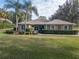 Charming home featuring a manicured lawn, lush landscaping, and decorative window accents enhancing its curb appeal at 39342 Harbor Hills Blvd, Lady Lake, FL 32159