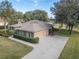 Detached two-car garage with decorative accents and a spacious driveway at 39342 Harbor Hills Blvd, Lady Lake, FL 32159