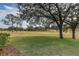 View of well-maintained golf course with mature trees scattered throughout the green at 39342 Harbor Hills Blvd, Lady Lake, FL 32159