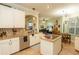 Open concept kitchen boasts granite counters, stainless steel appliances, and a view of the music room at 39342 Harbor Hills Blvd, Lady Lake, FL 32159