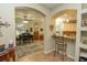 Kitchen featuring an island with bar seating, granite countertops, and open view to the music room at 39342 Harbor Hills Blvd, Lady Lake, FL 32159