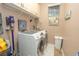 Laundry room featuring front load washer and dryer, storage shelving, and tiled floors at 39342 Harbor Hills Blvd, Lady Lake, FL 32159