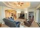 Expansive living room boasts a tray ceiling, decorative lighting, and seamless flow to other living spaces at 39342 Harbor Hills Blvd, Lady Lake, FL 32159