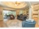 Spacious living room features a tray ceiling, tile flooring, and seamless access to the screened-in patio area at 39342 Harbor Hills Blvd, Lady Lake, FL 32159