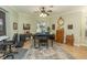 This music room features a ceiling fan and a grand piano over a decorative rug at 39342 Harbor Hills Blvd, Lady Lake, FL 32159