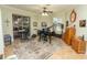 Well-lit music room with a grand piano and sliding glass doors to a screened patio at 39342 Harbor Hills Blvd, Lady Lake, FL 32159