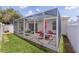 Enclosed patio and backyard with lawn and garden at 424 Valverda Dr, The Villages, FL 32162