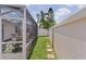 Backyard featuring screened patio, grassy area, and partial privacy fence at 424 Valverda Dr, The Villages, FL 32162