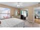 Well-lit bedroom with sliding glass doors to the patio and a view of a sunny day at 424 Valverda Dr, The Villages, FL 32162