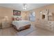 Comfortable bedroom with warm lighting and wood-look flooring, plus bed and dresser at 424 Valverda Dr, The Villages, FL 32162