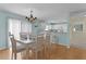 Open-concept dining area flowing into a kitchen with a breakfast bar at 424 Valverda Dr, The Villages, FL 32162
