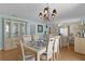 Open-concept dining area with hutch, chandelier, and access to living room at 424 Valverda Dr, The Villages, FL 32162
