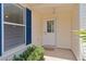 Inviting front entrance with a white door, blue shutters, and a neatly kept entryway at 424 Valverda Dr, The Villages, FL 32162