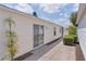Home exterior featuring sliding glass door to patio and sidewalk at 424 Valverda Dr, The Villages, FL 32162