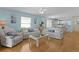 Bright living room with light blue walls, hardwood floors, and lots of natural light at 424 Valverda Dr, The Villages, FL 32162