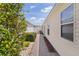 Well-kept side yard with concrete walkway and manicured landscaping at 424 Valverda Dr, The Villages, FL 32162
