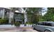 Charming condo exterior with gray facade, lush greenery, and a gray Range Rover in the parking area at 4300 Aqua Vista Dr # A, Orlando, FL 32839