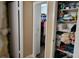 Hallway with a peek into the walk-in closet and storage shelves filled with organized items at 4300 Aqua Vista Dr # A, Orlando, FL 32839