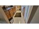 Galley kitchen boasts wooden cabinets, black countertops, tile floors, and includes washer and dryer at 4300 Aqua Vista Dr # A, Orlando, FL 32839