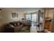 Bright living room featuring plush seating, a ceiling fan, and large windows for natural light at 4300 Aqua Vista Dr # A, Orlando, FL 32839