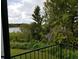 Balcony overlooking a scenic view of lush greenery and a serene lake at 4302 Aqua Vista Dr # G, Orlando, FL 32839