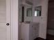 Bathroom features a white vanity with a mirrored medicine cabinet, vanity lighting, and a view of the toilet at 4302 Aqua Vista Dr # G, Orlando, FL 32839