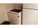 Close-up of a modern white Samsung washing machine with nearby white refrigerator at 4302 Aqua Vista Dr # G, Orlando, FL 32839