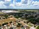 Overhead perspective of a neighborhood next to a large industrial structure in a rural landscape at 4680 Sw 142 Place Rd, Ocala, FL 34473